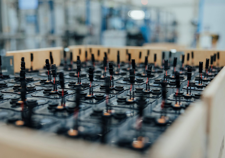 A wooden crate full of batteries. 